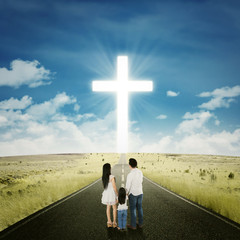 Family on the street with a cross