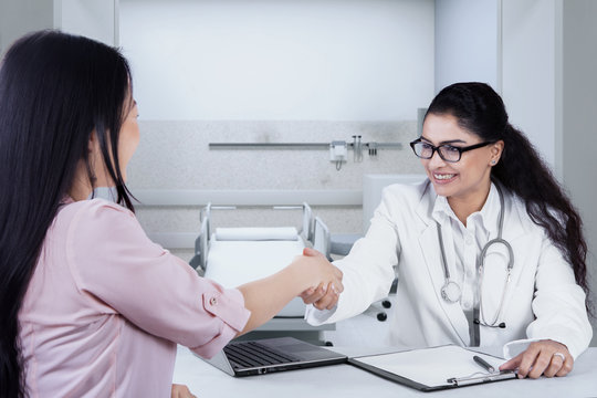 Female Doctor Shaking Hands To Patient