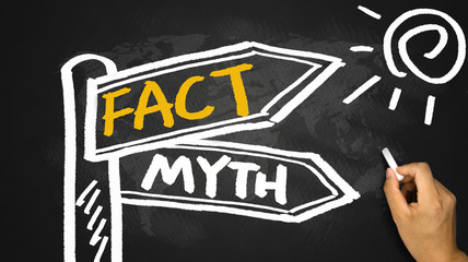 fact and myth signpost hand drawing on blackboard