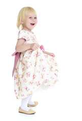 Little happy girl in a bright dress