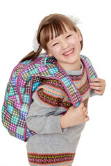 Cheerful girl with a backpack on his back