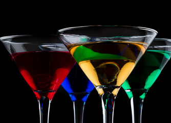 close up of color cocktails in martini glasses