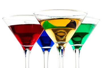 close up of color cocktails in martini glasses