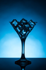 Martini glass filled with ice cubes