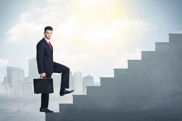 Businessman climbing up a concrete staircase concept