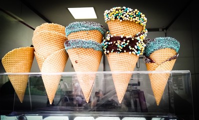 Ice cream in waffle cone in a shop