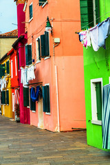 Fototapeta na wymiar Colorful houses in Burano with the laundry drying on a wire