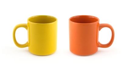 Two big empty yellow and orange cups isolated on white close up