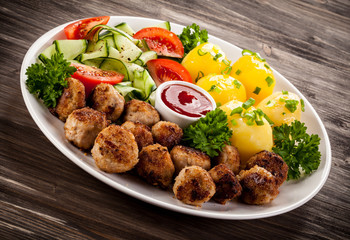 Roast meatballs, French fries and vegetable salad