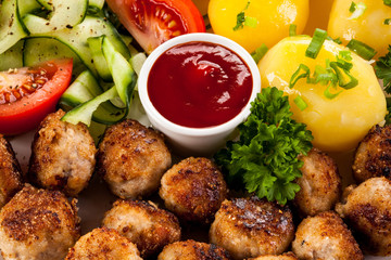 Roast meatballs, French fries and vegetable salad