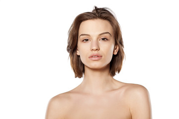 young beautiful woman without make-up on a white background