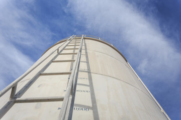 Fototapeta na wymiar High steel ladder on big water tank