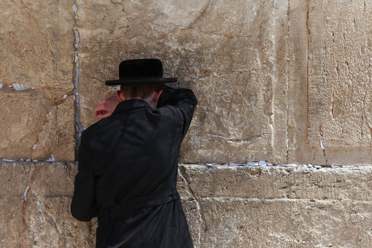 Orthodox Jewish man pray at the western wall - Jerusalem, Israel