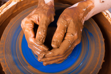 hands working on pottery wheel