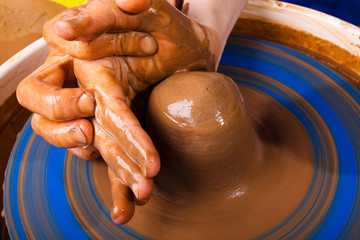 Potter teaches to work with clay on pottery wheel