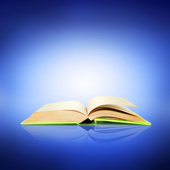 Opened book on bright blue background