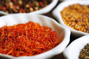 Different kinds of spices in ceramics spoons, close-up,