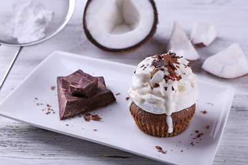 Delicious coconut cupcake with cream and chocolate chips