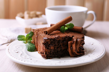 Tasty piece of chocolate cake with mint and cinnamon