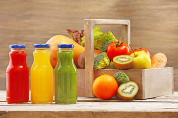 Glass bottles of fresh healthy juice with set of fruits and