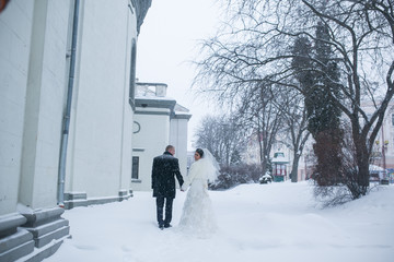 Fototapeta premium the bride and groom on the background of a winter city