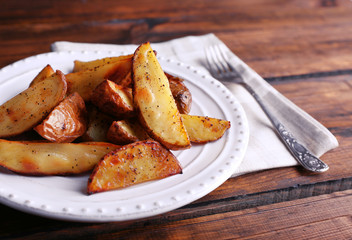 Baked potatoes on pate on wooden table
