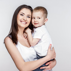 happy mother with a child on light grey background