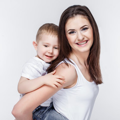 happy mother with a child on light grey background