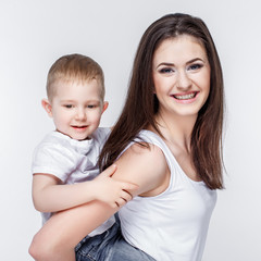 happy mother with a child on light grey background