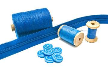 spools of blue thread and buttons on white