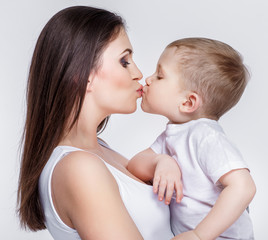 happy mother with a child on light grey background