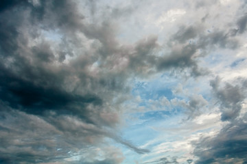 Naklejka na ściany i meble Blue sky with storm clouds at sunset