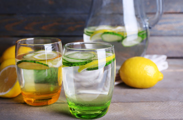 Fresh water with lemon and cucumber in glassware