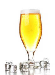 Glass of beer with foam and ice cubes isolated on white