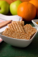 Biscuits from sesame seeds and honey in square bowl
