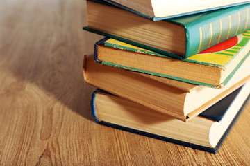 Old books on wooden table, closeup