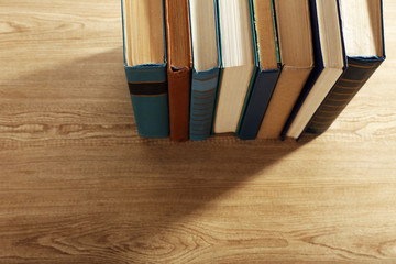 Old books on wooden table, top view