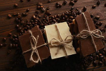 Fototapeta na wymiar Stack of tied chocolate with coffee beans on wooden background
