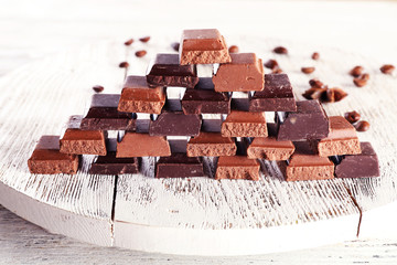 Pyramid of squared chocolate on wooden table