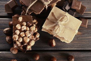 Set of chocolate with hazelnut on wooden table, closeup