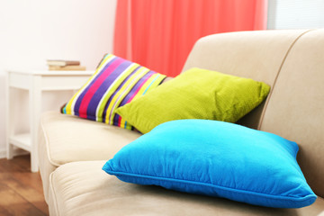 Fototapeta na wymiar Interior design with pillows on sofa, closeup