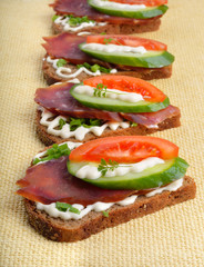 Sandwich with smoked meat and vegetables