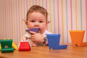 baby playing color woods