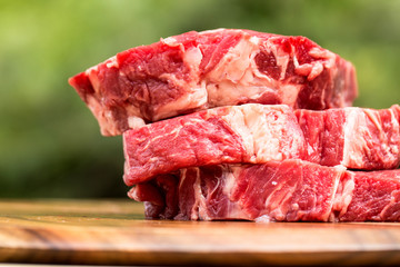 Fresh beef steaks on wooden board