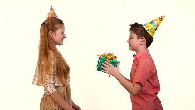 Little boy gives a girl  box with gift green birthday. white