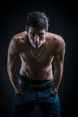 Obraz na płótnie Canvas Handsome muscular shirtless young man standing confident