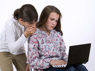 Two teenagers with a portable computer