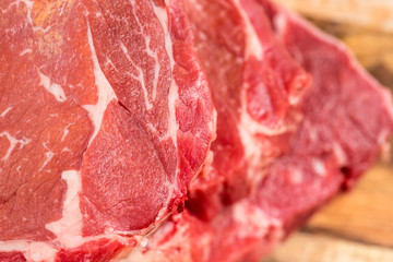 Fresh beef steaks on wooden board