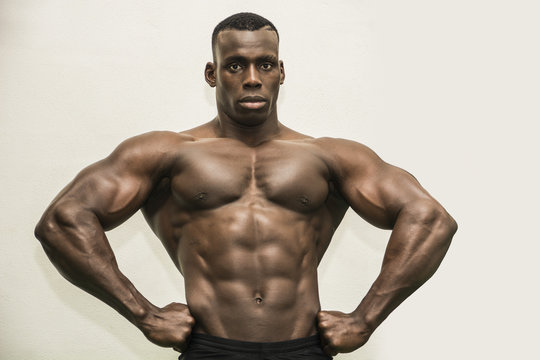 Handsome black male bodybuilder posing in studio