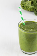 Green smoothie with striped straw